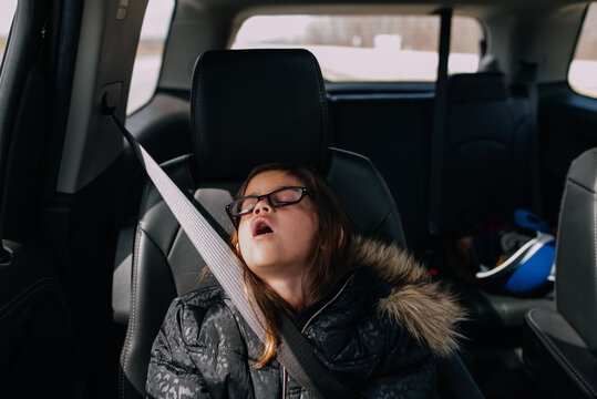 Girl sleeping with mouth open in the car. 