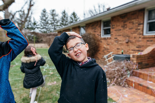Young boy covered in silly string. 