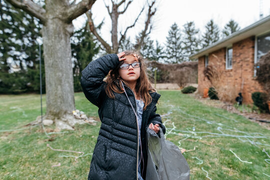 Girl covered in silly string looking for Easter eggs. 