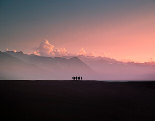 Group of friends walking at sunset