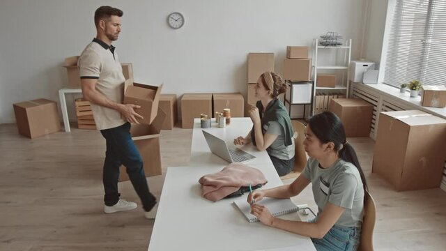 High-angle shot with slowmo of kind generous people bringing food and old clothes in boxes donating them for nonprofit charity organization