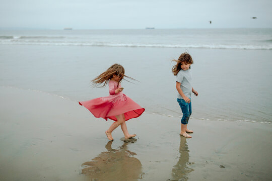 Girl watches sister dress billow out