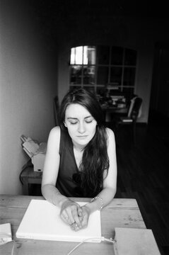 A film portrait of young beautiful woman lying on her working place