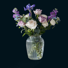 Bouquet of hackelia velutina, purple and white roses, small tea roses, matthiola incana in glass vase isolated on black background