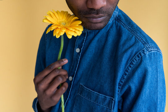 Anonymous Black Man Holding Flower