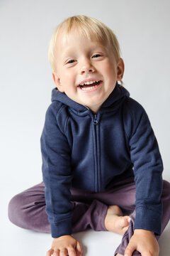 Portrait of a happy blonde boy in studio