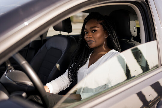 Black woman inside her new car