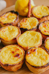 Portuguese egg custard tart with towel background and cinnamon stick - Pasteis de Nata or Pastel de Belem