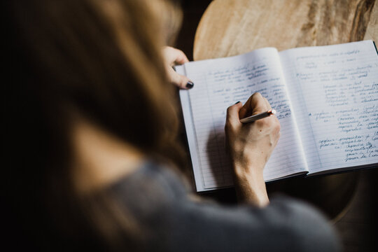 Woman writes in a notebook 