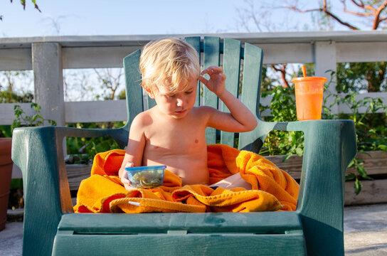 Little Boy With A Snack By The Pool