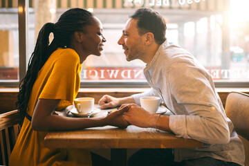 Happy diverse couple during date in cafe