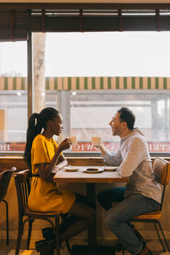 Happy diverse couple during date in cafe