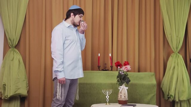 Before the chuppah ceremony, the Jewish groom is in the synagogue hall and makes kiddush for wine.