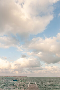 Solitary boat in the Caribbean with puffy white clouds