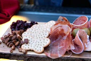 Prosciutto meats, nuts and raisins on a charcuterie board
