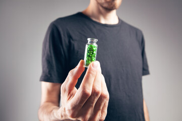 a man holding a pill in his hand