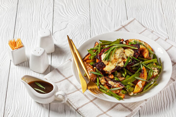 pork steaks topped with blue cheese and veggies
