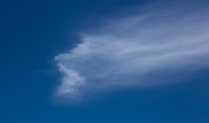 Naklejka na ściany i meble Blue, beautiful sky background. Oddly shaped clouds in a blue sky