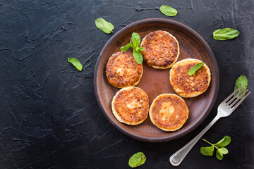 A healthy breakfast of cheese pancakes and honey. Creative atmospheric decoration
