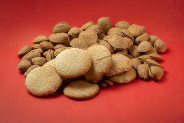 homemade sweet almond cookies. Orange background with almonds.