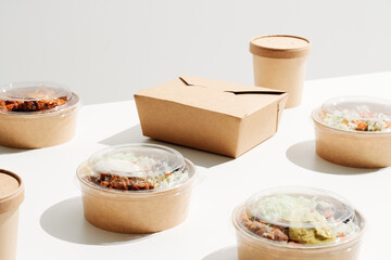 Variety of carton takeaway containers with food and drinks