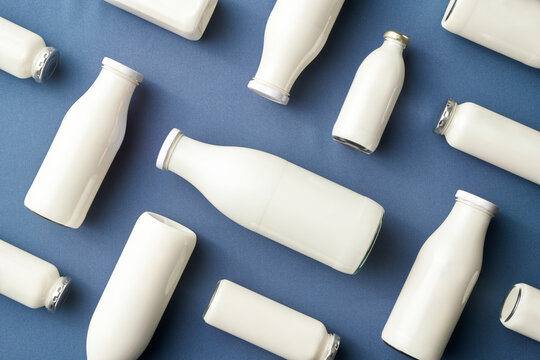 White milk bottles on blue background