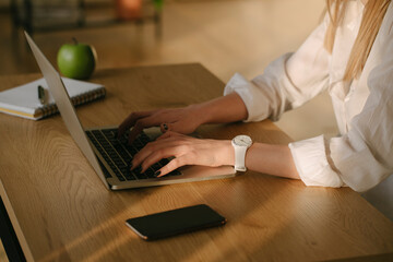 Anonymous lady browsing on laptop