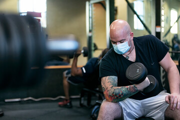 Gym: Man With Face Mask Does Bicep Curls