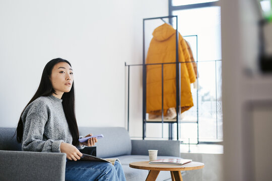Woman reacting on notification in hallway 