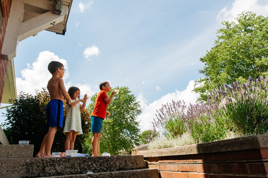 Throwing ball off the front porch. 