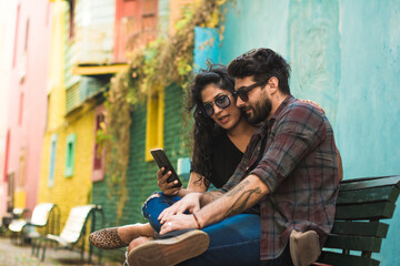 Couple checking directions on their phone while on vacation