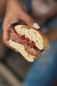 Woman's hand holding a choripan