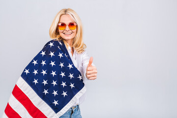 Smiling senior beautiful patriotic woman wearing united states flag isolated over white background with a surprise face.