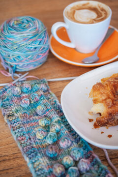 Knitted rainbow scarf at a cafe