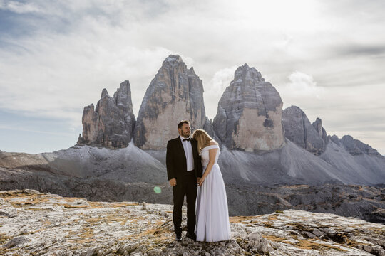 Wedding Couple Holding Hands In Front Of A Dolomity Mountain