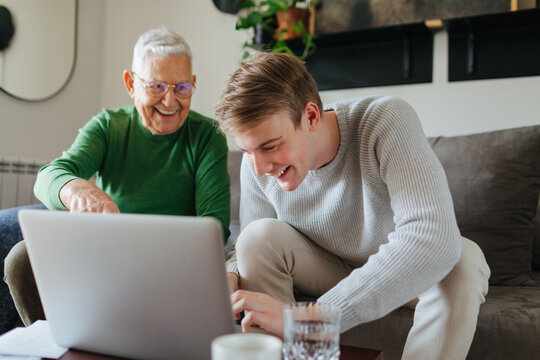Young Man and His Grandfather at Home