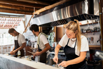 Focused Chefs Cooking in Kitchen