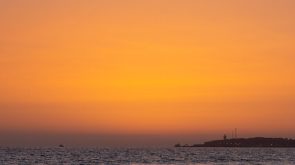 Lighthouse sunset, orange sky