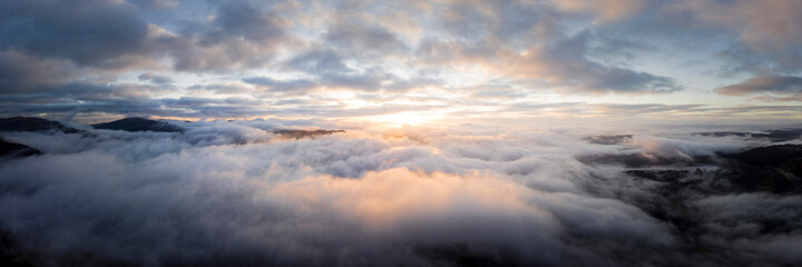Aerial above a cloud inversion at sunrise lake district