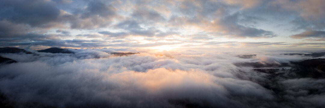 Fototapeta Aerial above a cloud inversion at sunrise lake district