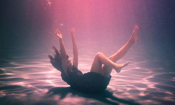 Woman falling on the bottom of the pool