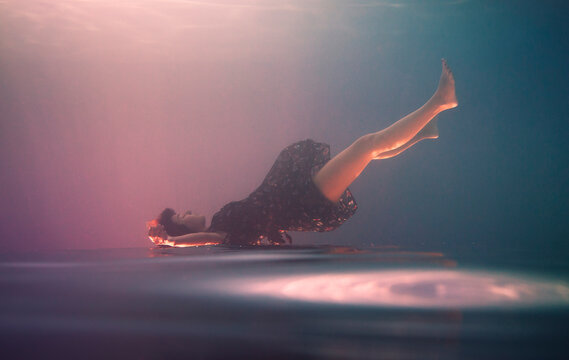 Underwater portrait of an upside down girl 
