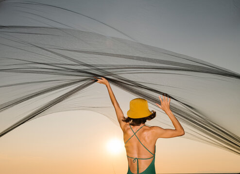 model playing with black tulle fabric