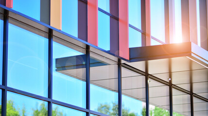 Reflection of modern commercial building on glass with sunlight. Geometric structure glass windows. 