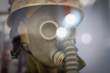 Fototapeta premium The old uniform of a fireman in a gas mask.