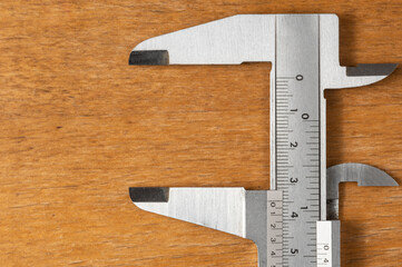 verniers calipers on wooden base with free space