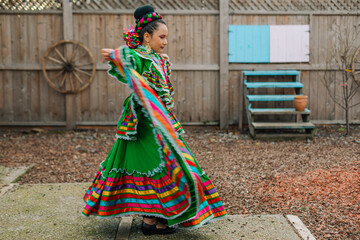 Portrait of a Mexican-American tween wearing a traditional Mexican dress