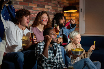 Excited young people watching sport match, chsmpionship at home, cheering for favourite national basketball, tennis, soccer, hockey team. Concept of emotions.