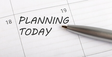 Text PLANNING TODAY on calendar planner to remind you an important appointment with a pen on isolated white background.