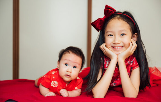 Two young sisters at home